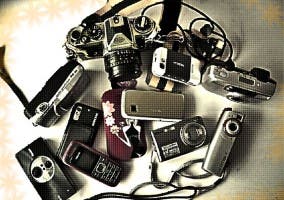 Varias cámara y móviles amontonados